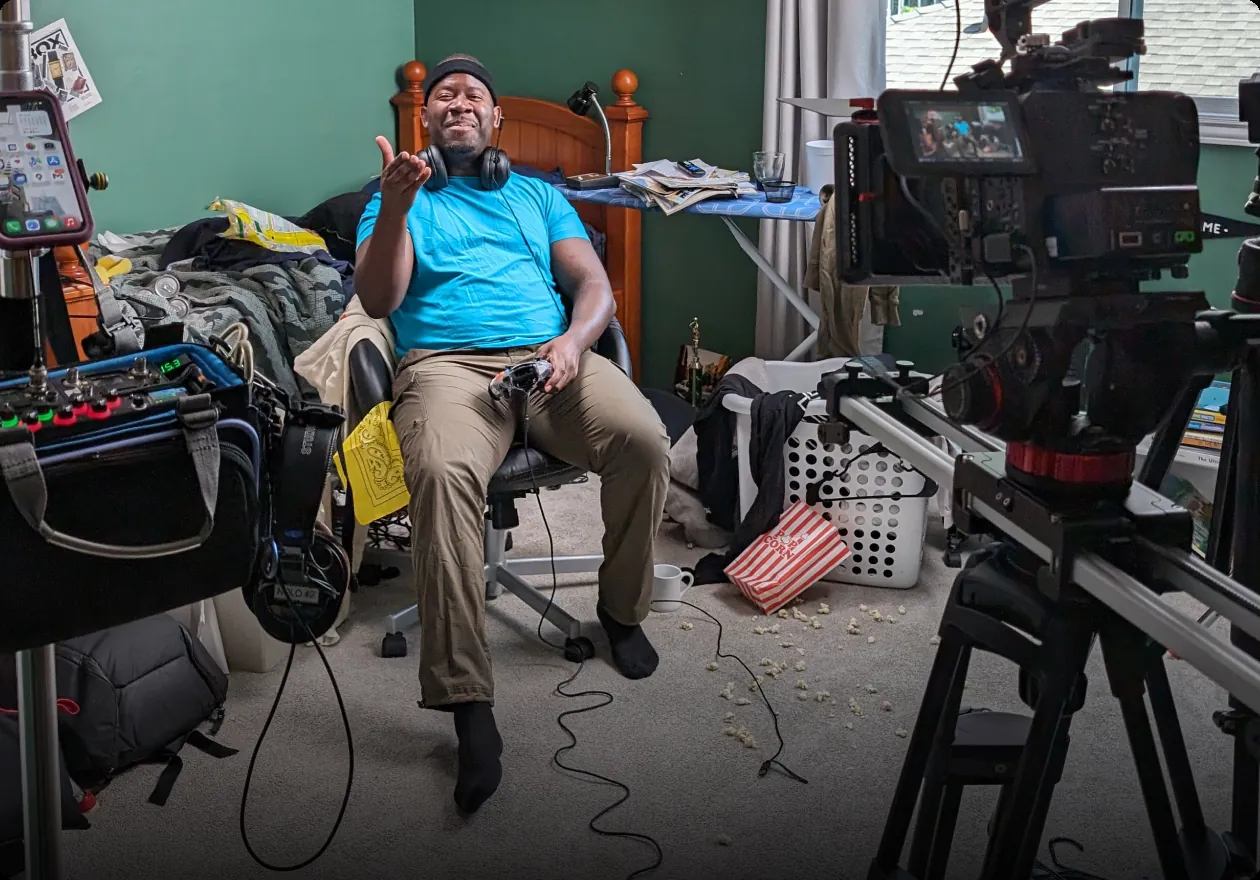 A comedian cast for a shoot, sitting on set